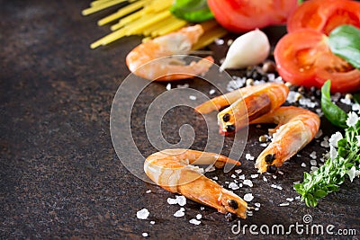 Culinary background for cooking with pasta, shrimps, tomatoes, fresh herbs and spices. Stock Photo