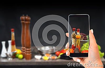 Culinary blog concept with hand shoots the cooking process on the smartphone. Stock Photo