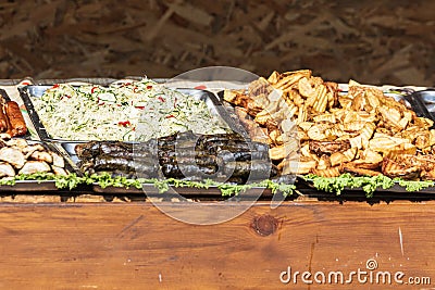 Culinary buffet with a presentation of a variety of healthy food - meat, sausage, grilled vegetables. Stock Photo