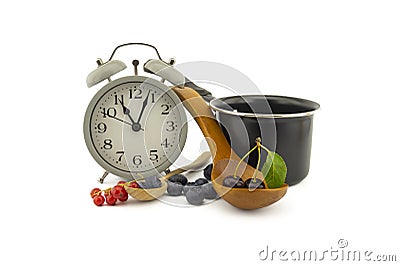 Culinary still life with clock, pot and berries Stock Photo