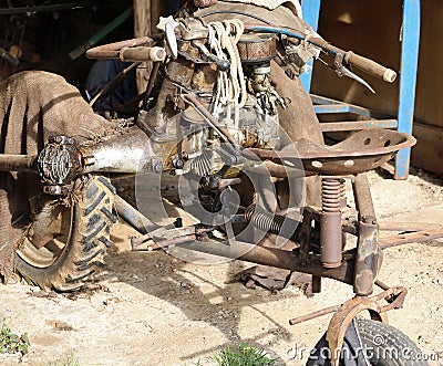 Cultivator old and rusty abandoned in a garage of the farm stora Stock Photo