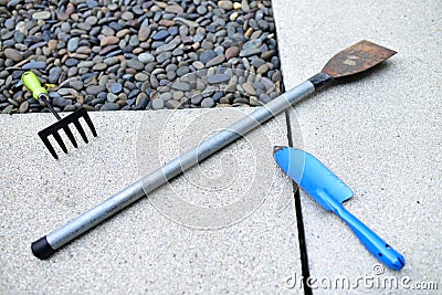 Cultivators, forks and other tools are laid on the ground. Stock Photo