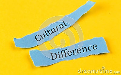 CULTURAL DIFFERENCE text on a blue pieces of paper on yellow background, business concept Stock Photo