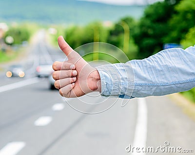 Cultural difference. Thumb up inform drivers hitchhiking. But in some cultures gesture offensive risk to be killed by Stock Photo