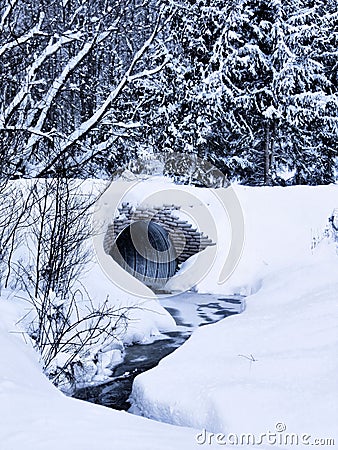 Culvert and stream in winter Stock Photo