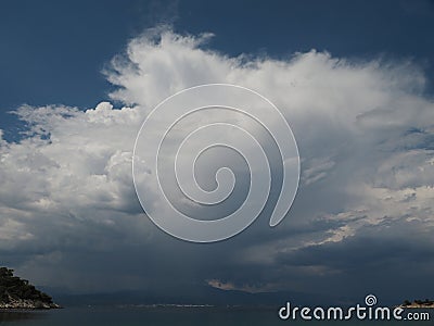 Cumulonimbi storm cloud over mainland across Saronic Gulf Greece Stock Photo