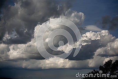 Cumulous clouds against dark sky Stock Photo