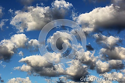 Cumulus white puffy fluffy clouds against deep blue sky Stock Photo