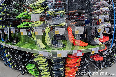 Colorful Football shoes or soccer ball boots displayed in shelves Editorial Stock Photo