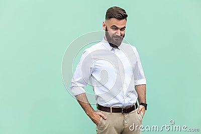 Cunning businessman, hid his hands in his pockets and looking slyly at camera. Stock Photo