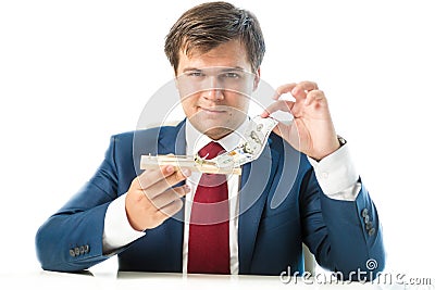 Cunning businessman taking dollar bill out of mousetrap Stock Photo