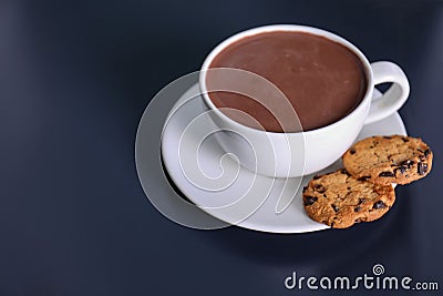 Cup of aromatic cacao with cookies on dark table. Stock Photo