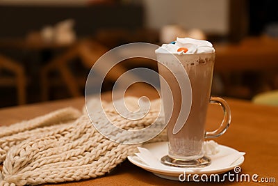 Cup of aromatic cacao and knitted scarf Stock Photo