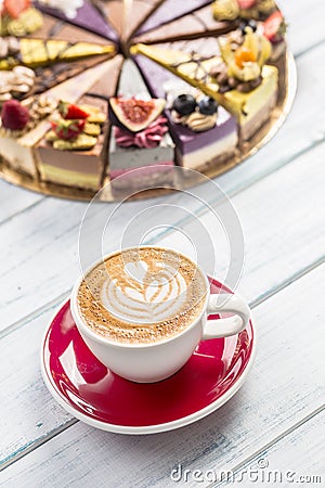 A cup of art coffee cappiciino and mini raw cakes Stock Photo