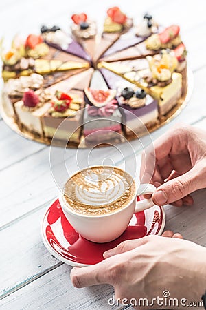 A cup of art coffee cappiciino and mini raw cakes Stock Photo