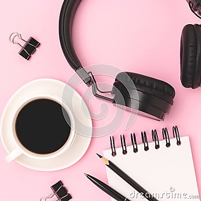 Cup of black coffee, headphones, notepad and stationery. Stock Photo