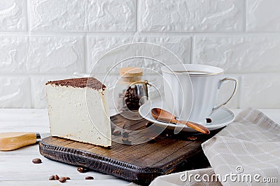 cup of black coffee with a piece of soft cheese in ground coffee Stock Photo