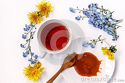 Cup of black tea with honey and flowers forget-me-nots and dandelions on a white background Stock Photo