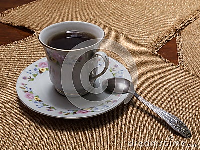 A cup of black tea on a saucer is on the table with napkins Stock Photo