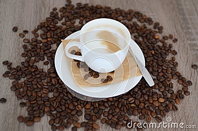 Cup of cappuccino and coffee beans Stock Photo