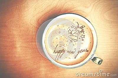 Cup of cappuccino coffee on wooden table. Words Happy New Year f Stock Photo