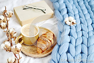 Cup with cappuccino, croissant, blue pastel giant plaid Stock Photo