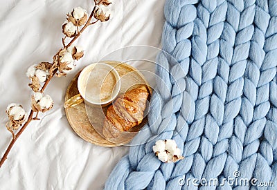 Cup with cappuccino, croissant, blue pastel giant plaid Stock Photo