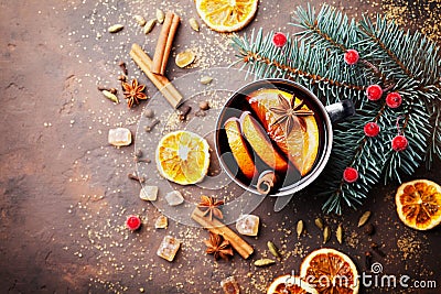 Cup of christmas mulled wine or gluhwein with spices and orange slices on rustic table top view. Traditional drink on winter. Stock Photo