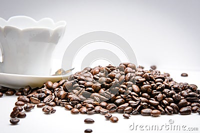 Cup of coffe alongside with coffe beans on white background Stock Photo