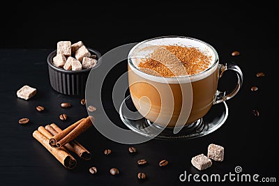 Cup of coffe with milk on a dark background. Hot latte or Cappuccino prepared with milk on a black wooden table Stock Photo