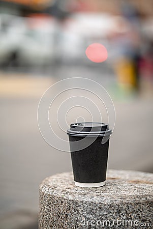Cup of coffee on bench on the city street town coffeebreak daylight bokeh Stock Photo