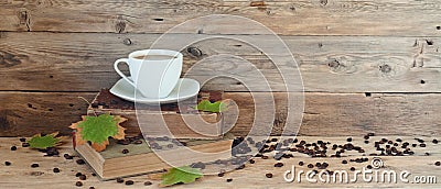 Cup of coffee on the books in autumn maple leaves Stock Photo