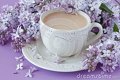 Cup of coffee and branches of blooming lilac Stock Photo