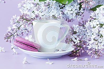 Cup of coffee and branches of blooming lilac Stock Photo