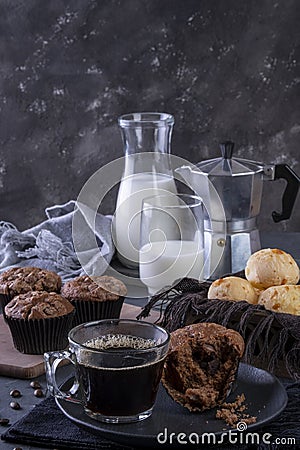 A cup of coffee, chocolate muffins, cheese breads and milk Stock Photo