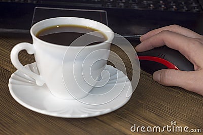 A cup of coffee computer, mouse, hand, wooden background mouse Stock Photo