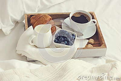 Cup of coffee, croissant and fresh blueberry on wooden tray, bre Stock Photo