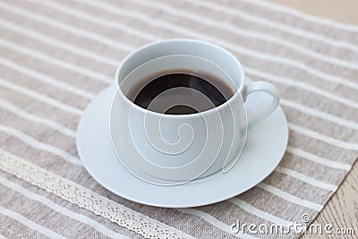 A cup of coffee on cute fabric. Stock Photo