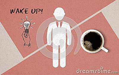 Cup of coffee and a drawn person in a Wake Up concept on paper background with the message WAKE UP Stock Photo