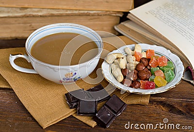 Cup of coffee with dry fruits and chocolate on napkin Stock Photo