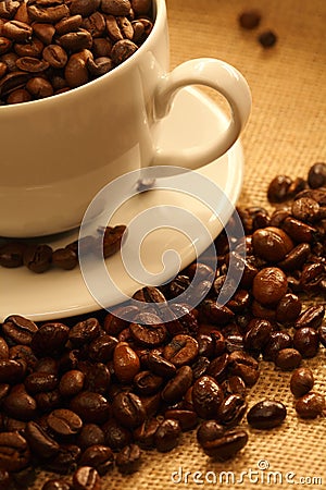 Cup of coffee, full of beans. Stock Photo