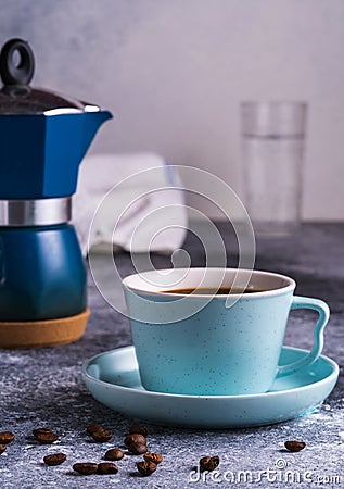 A cup of coffee and Geezer coffee maker under blurred bokeh background Stock Photo