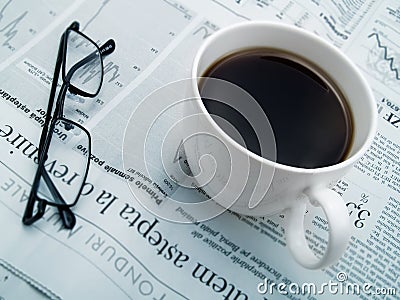 A cup of coffee, glasses and a newspaper Stock Photo