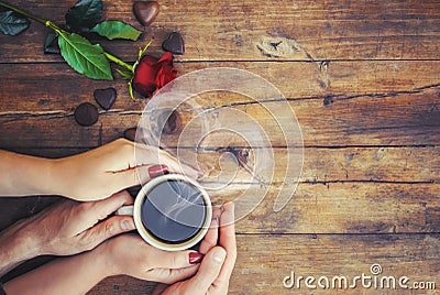 A cup of coffee in the hands of lovers. Stock Photo