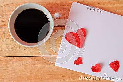 Cup of coffee and hearts on a wooden background. Coffee on calendar. valentine day with coffee concept. Stock Photo