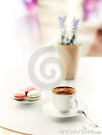 A cup of coffee with macaroons and lavender on table Stock Photo