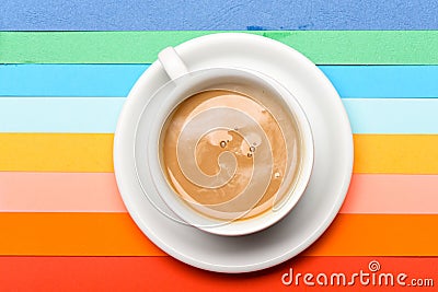 Cup of coffee with milk or cappuccino beverage on colorful as rainbow background. Dose of energy concept. Coffee on Stock Photo