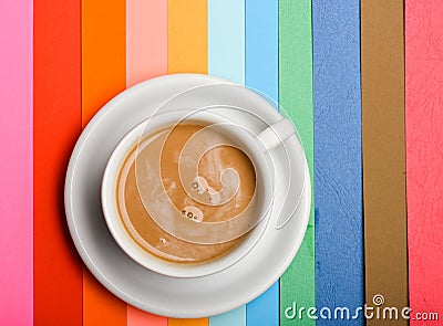 Cup of coffee with milk or cappuccino beverage on colorful as rainbow background. Dose of energy concept. Drink with Stock Photo