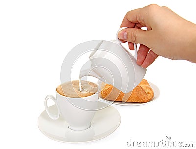 Cup of coffee, milk jug and fresh bakery Stock Photo