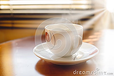 Cup of coffee in the morning sunshine Stock Photo